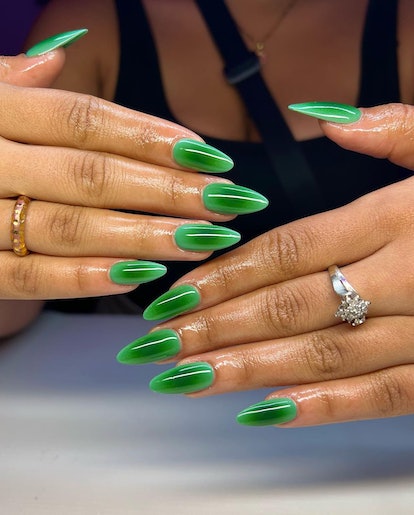 Vibrant green aura nails that match the cabincore aesthetic.