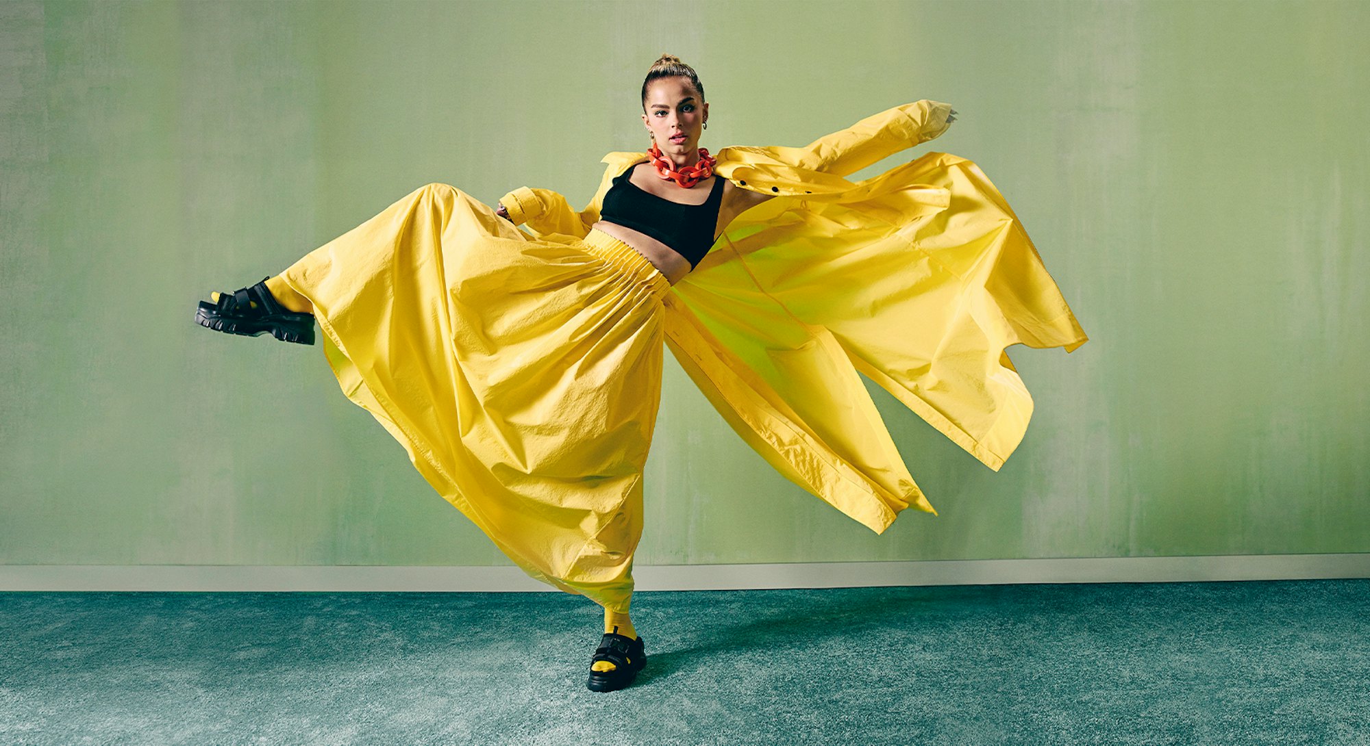 TikTok star Addison Rae wears a yellow outfit as she appears on Bustle's cover.