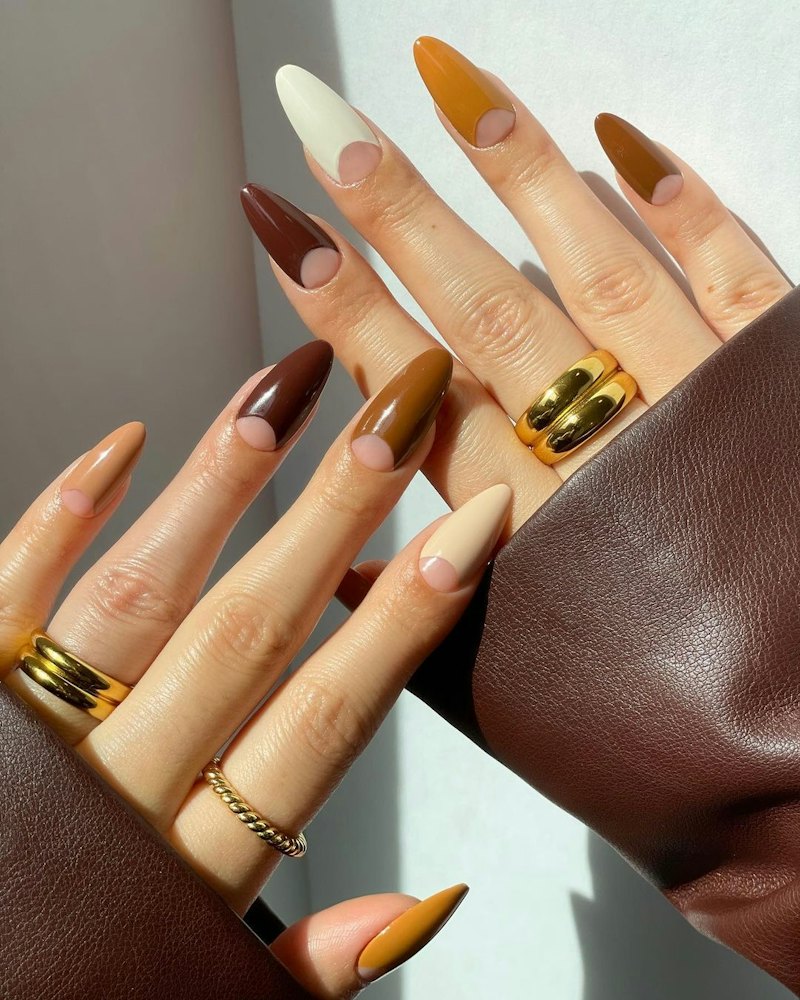With a mix of brown nail polish shades, this half moon manicure is the perfect nail art design for f...
