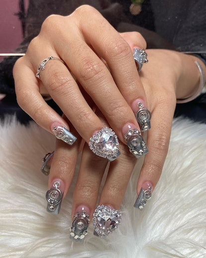 "More is more" silver gems and crystals that match the 3D chrome nail art trend.