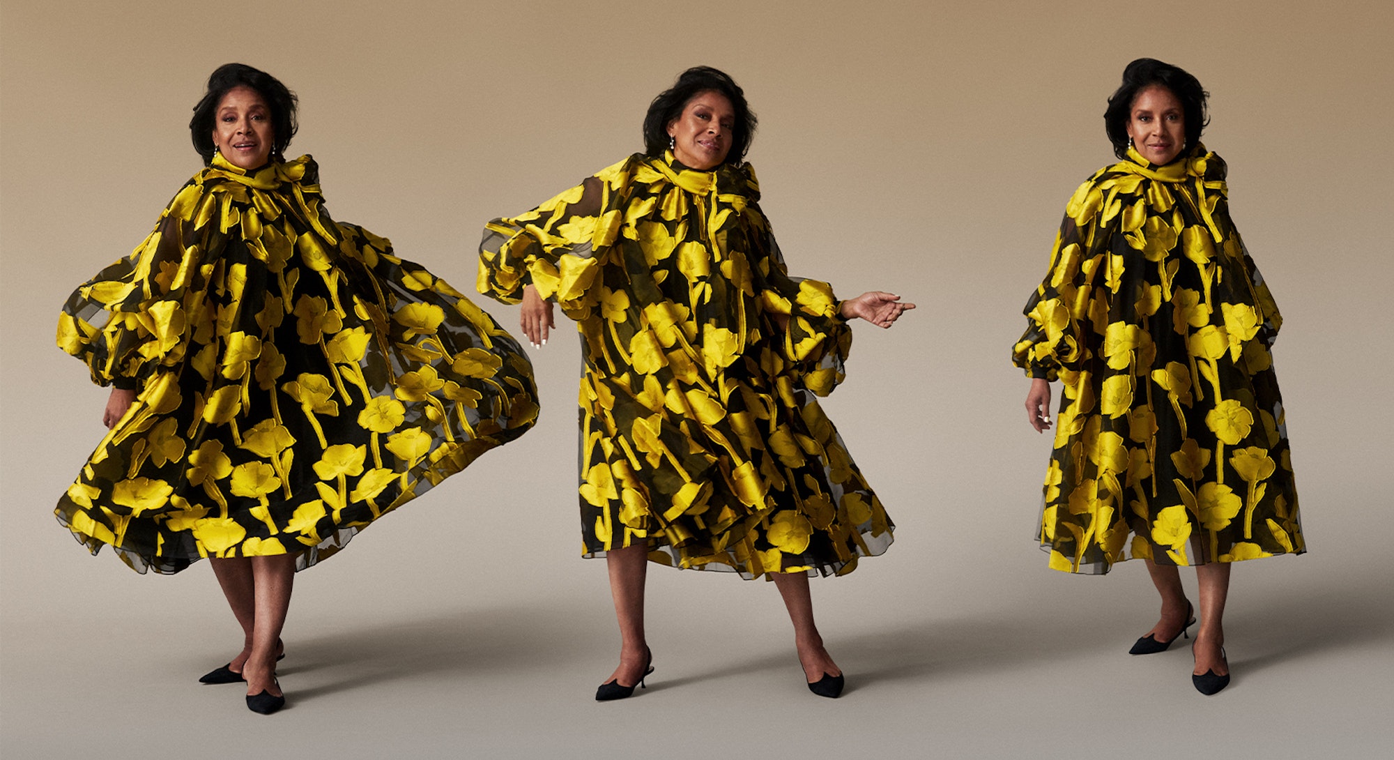 Phylicia Rashad in a black yellow flower motived dress and scarf
