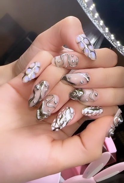 A silver 3D chrome nail design to consider for winter 2024.