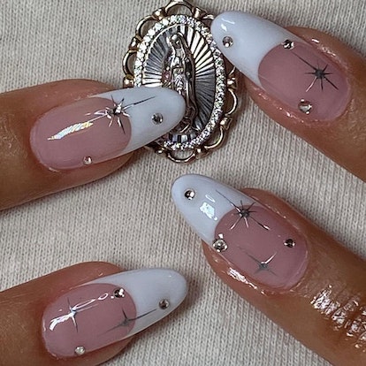 Classic French nails with celestial designs that match the 3D chrome nail art trend.